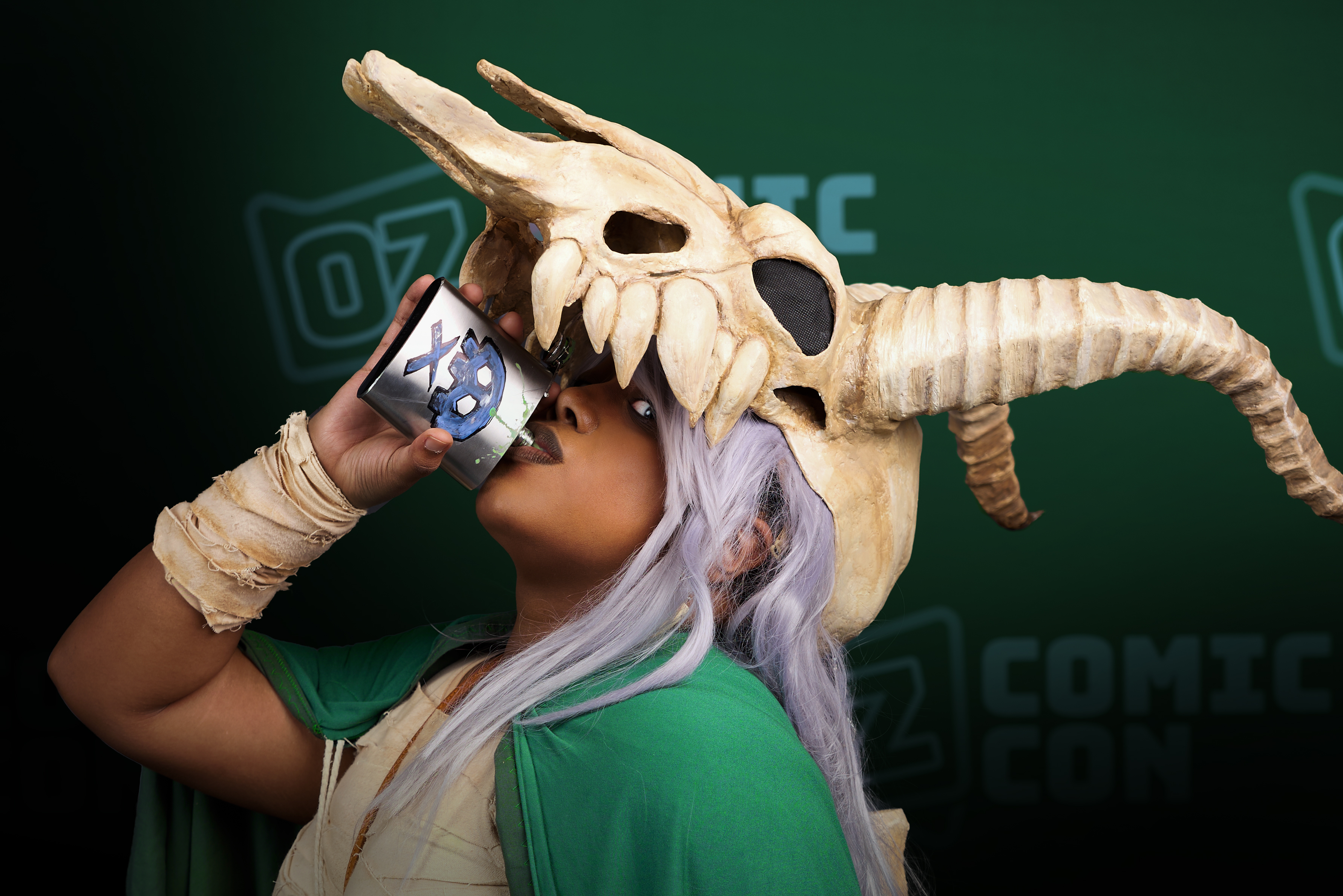 A cosplayer in an intricate Silent costume drinking from a Bouncing Flask.