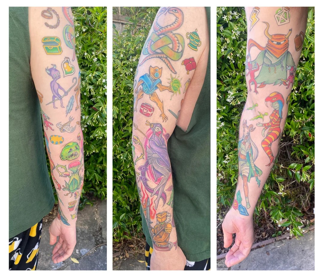 Multiple sides of an arm decked out with a full sleeve of Slay the Spire tattoos.